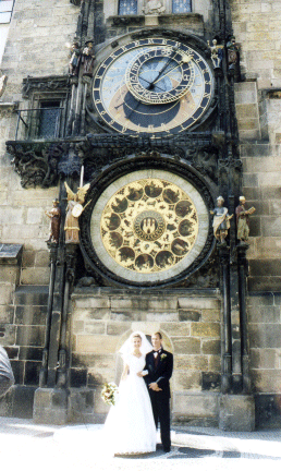 A Bride and Groom Pose under the Astonomical Clock in Prague, Czech Republic